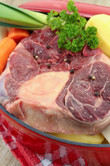 vegetables and raw meat for pot on fire on a wooden table