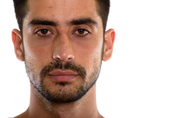 Close up of young Persian man looking at camera