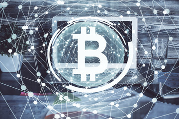 Multi exposure of blockchain theme hologram and table with computer background. Concept of bitcoin crypto currency.