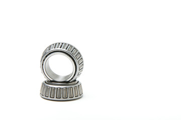 background of auto parts on a white background. tapered bearings on white background