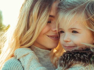 young mother with daughter in the autumn forest. happy motherhood. mother hugs a child.