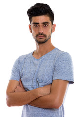 Obraz premium Studio shot of young Persian man with arms crossed