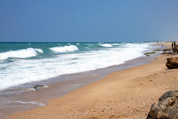 Sea beach with stone formations and incident foam waves on the shore of Ashkelon National Park