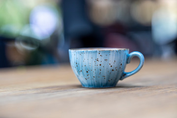 blue coffee mug on the wooden table
