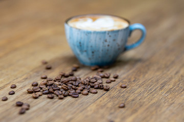 blue coffee mug and coffee beans