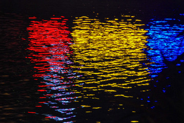Red, yellow and blue colors reflected in a water