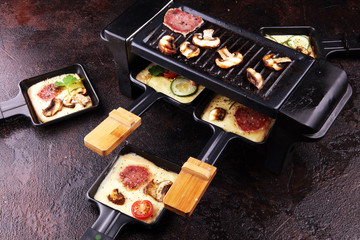 Delicious traditional Swiss melted raclette cheese on diced boiled or baked potato.
