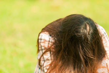 woman sat seated on a chair in the garden. The fatigue of work. From illness