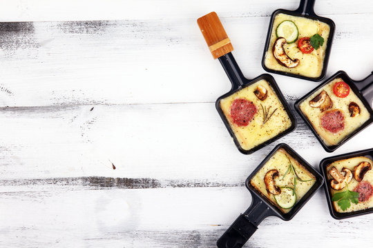 Delicious traditional Swiss melted raclette cheese on diced boiled or baked potato.