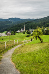 Austria - July, 2019: Country road in the alps village in Austria