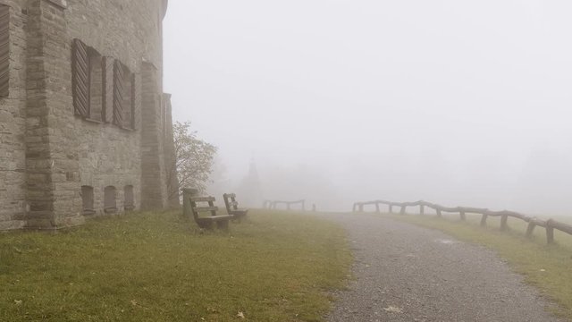 Large Estate with Old Windows and Benches Stands Shrouded in a Thick Blanket of Fog at grosser Feldberg, Frankfurt, Hessen, Germany