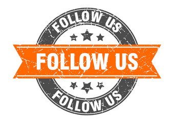 follow us round stamp with orange ribbon. follow us