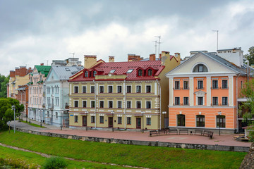 Fototapeta na wymiar Pskov, old colorful buildings on the Golden embankment of the Pskova river