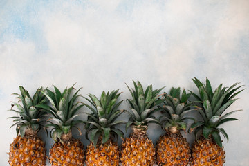 Fototapeta premium Fresh pineapples on light background.
