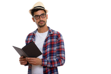 Young bearded Persian tourist man reading book