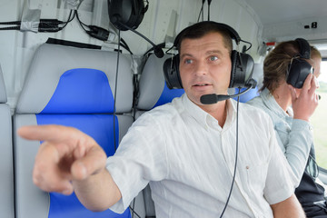couple in aircraft man pointing out of window