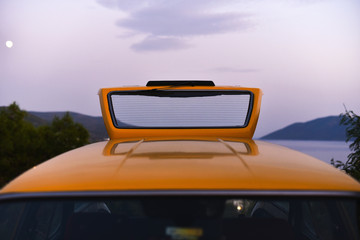 open back trunk of taxi station wagon car on background sky in dusk
