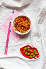 pasta dish and olives on white table, healthy diet food