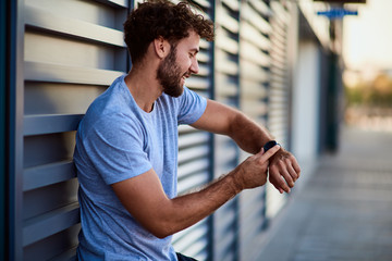 Sportsman making pause during exercising in urban area.