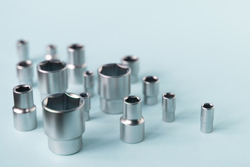 Bits set for ratchet wrench on the soft blue background. Tools for home workers, factory workers, auto mechanics and other works.