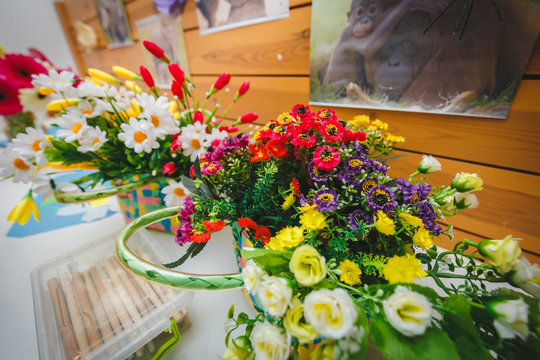 Colorful multi-colored flowers in basket in Education Centre. img photo for school or Kindergarten