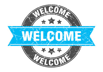 welcome round stamp with turquoise ribbon. welcome