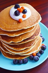 Delicious pancakes with sour cream and berries.