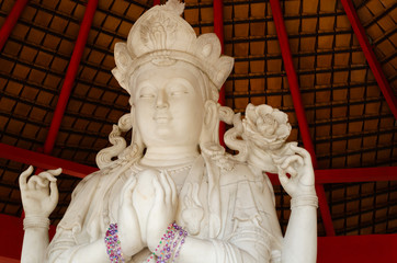 Lovely white marble four armed buddha in deep meditation