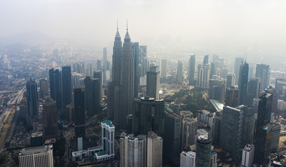 View from above, stunning aerial view of Kuala Lumpur skyline with beautiful skyscrapers and towers during a foggy day. Kuala Lumpur, Malaysia