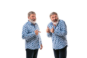 Senior man arguing with himself on white studio background. Concept of human emotions, expression,...