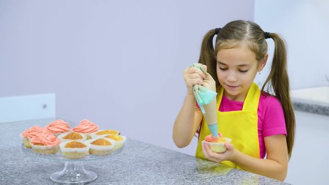 Smiling girl takes out the capcake from the gift box