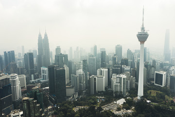 View from above, stunning aerial view of Kuala Lumpur skyline with the magnificent KL Tower and other skyscrapers during a foggy day. Kuala Lumpur, Malaysia