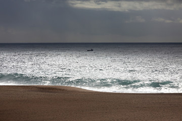 Landscape with a small boat in the ocean