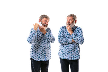 Senior man arguing with himself on white studio background. Concept of human emotions, expression,...