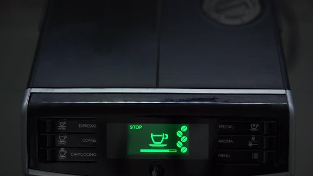 coffee machine prepares beverage and shows progress line on green colorful display panel with cup and beans image macro