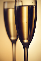 Two glasses of champagne on a blurred background. Celebration concept. Selective focus. Background with copy space.