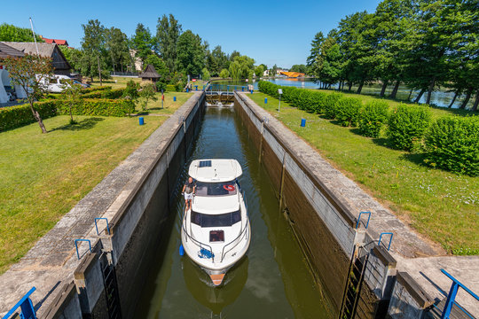 Boat entering gateway sluice (locks) on the Augustow Canal, Poland.