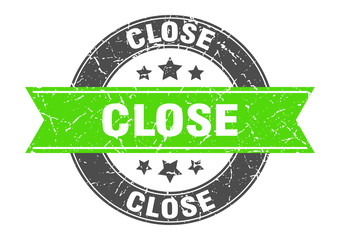 Obraz premium close round stamp with green ribbon. close