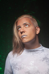 Fototapeta na wymiar shaved young blond caucasian man on dark studio background