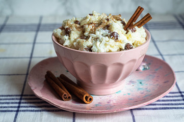 traditional rice pudding with cinnamon, milk and raisins