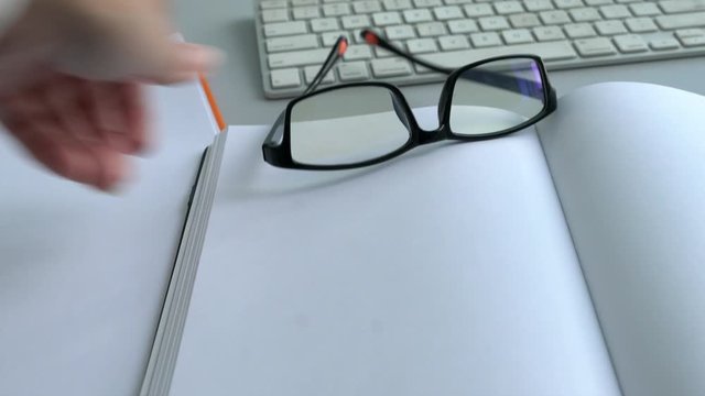 Throwing reading glasses and brown envelope with words, I Quit on an office table. Resign or quit job concept.
