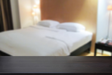 Fototapeta na wymiar Black marble table top with bed blurred background.