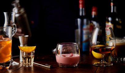 Assorted fruity cocktails and cognac in a snifter