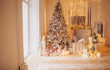 classical interior of a white room with a decorated fireplace, luxury Christmas tree, garlands,...