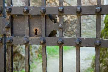 Old lock detail on iron bars. Pernstej Castle, Czech Republic