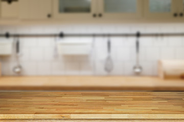 Wooden table top, desk space and blurred of kitchen background. Can be used for product display montage. business presentation.
