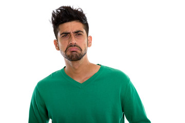 Studio shot of young Persian man looking sad