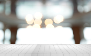 White wood table top with reflect on blur of lighting in nice cafe, restaurant background, selective focus.