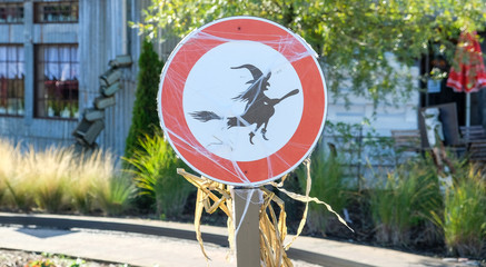 funny witch on a road sign