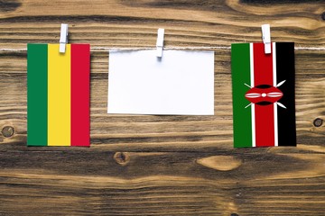Hanging flags of Bolivia and Kenya attached to rope with clothes pins with copy space on white note...